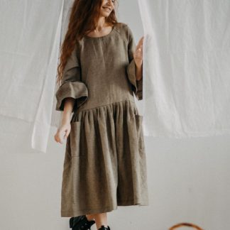 Woman in an olive linen smock dress